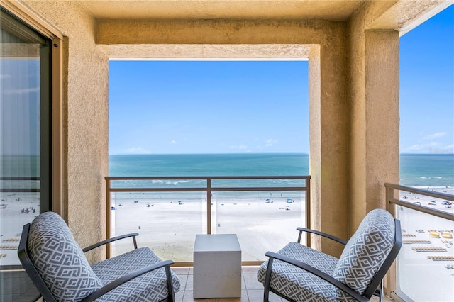 balcony with a view of the beach and a water view