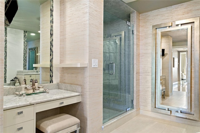 bathroom with tile patterned floors, a shower with shower door, and vanity