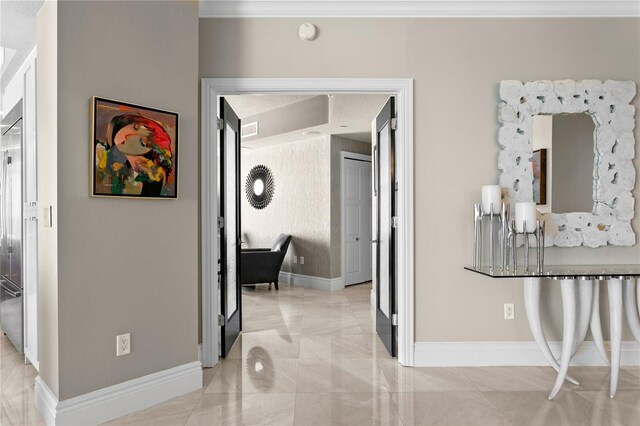 corridor with marble finish floor, visible vents, crown molding, and baseboards