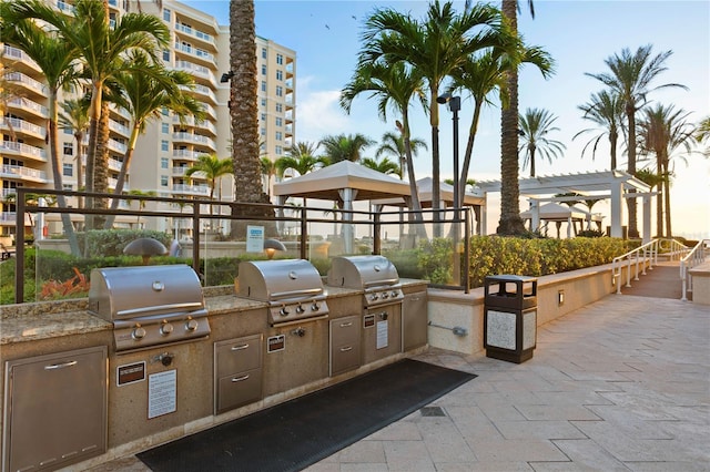 view of patio / terrace featuring an outdoor kitchen, grilling area, and a pergola