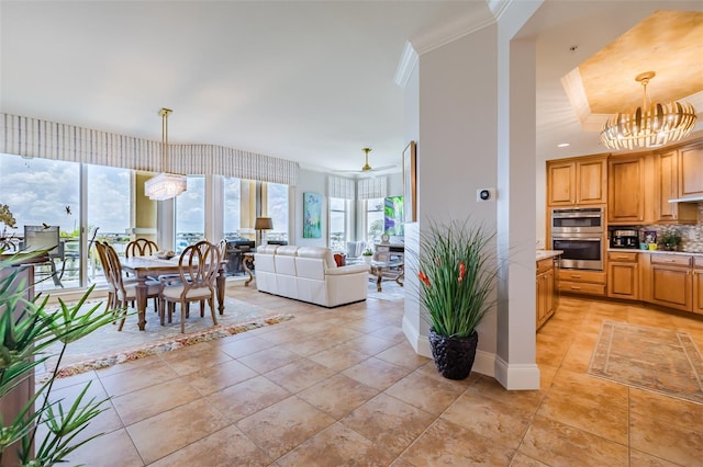 interior space with crown molding and ceiling fan with notable chandelier