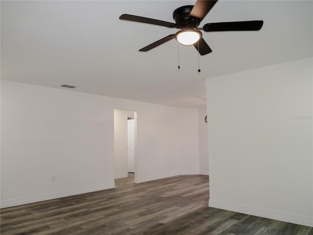 unfurnished room with visible vents, baseboards, wood finished floors, and a ceiling fan