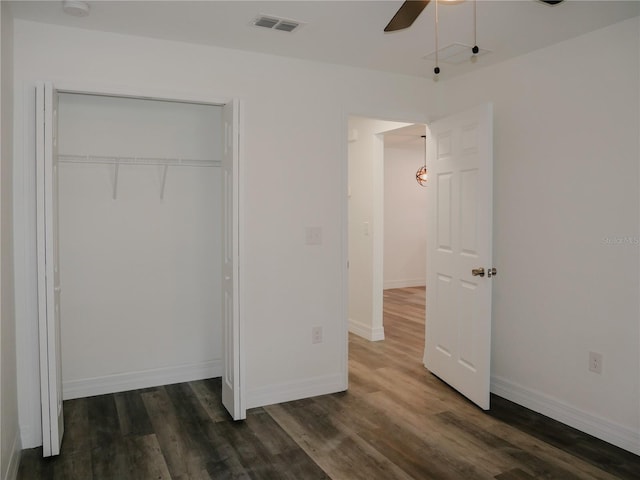 unfurnished bedroom featuring ceiling fan, a closet, and dark hardwood / wood-style floors