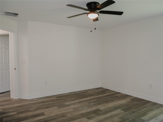 spare room with visible vents, a ceiling fan, baseboards, and wood finished floors