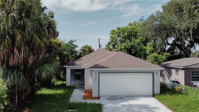 ranch-style home featuring a shingled roof, fence, concrete driveway, stucco siding, and an attached garage