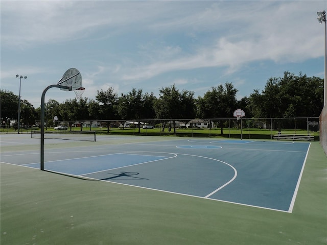 view of basketball court featuring community basketball court and fence