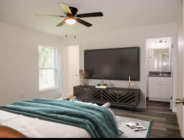 bedroom with ensuite bath, dark hardwood / wood-style flooring, and ceiling fan