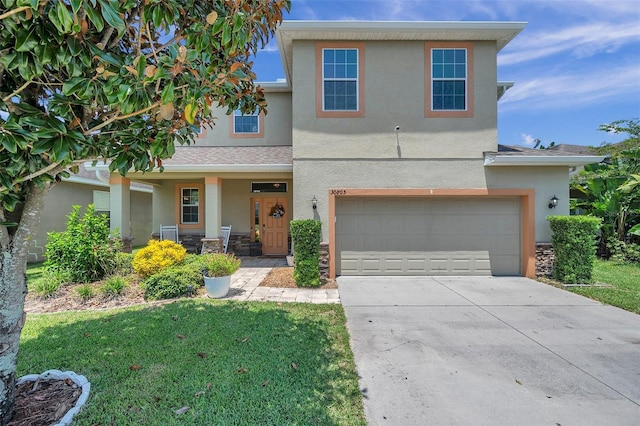 view of front of house featuring a garage and a front lawn