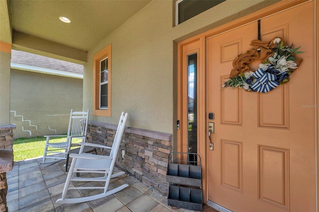 view of exterior entry with covered porch