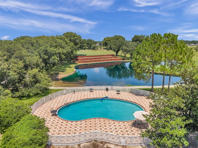 view of swimming pool featuring a water view