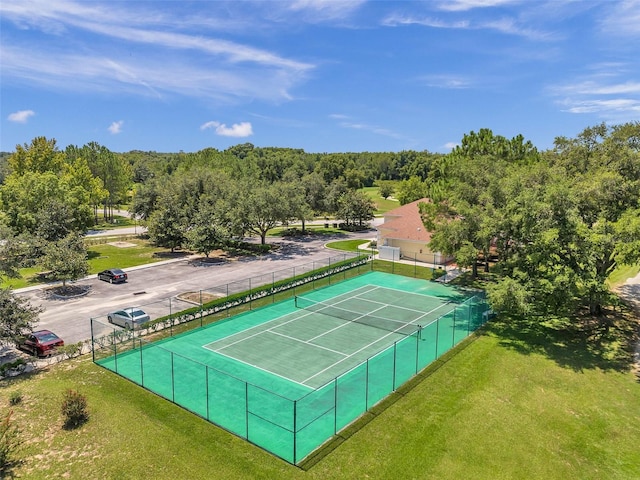 view of sport court featuring a lawn