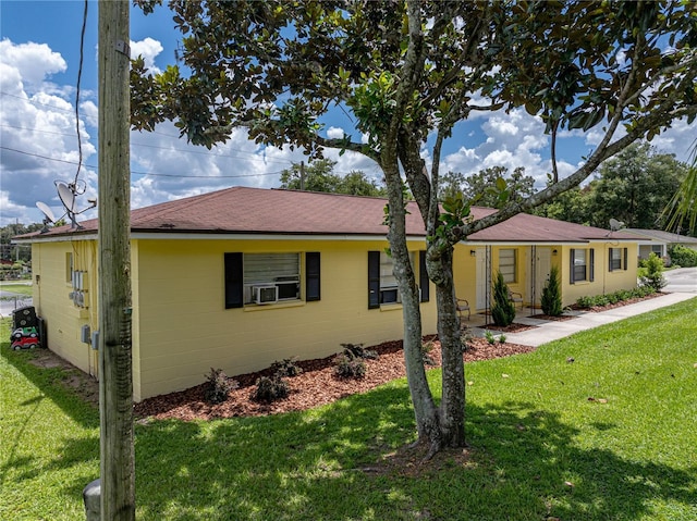 single story home with a front yard and cooling unit