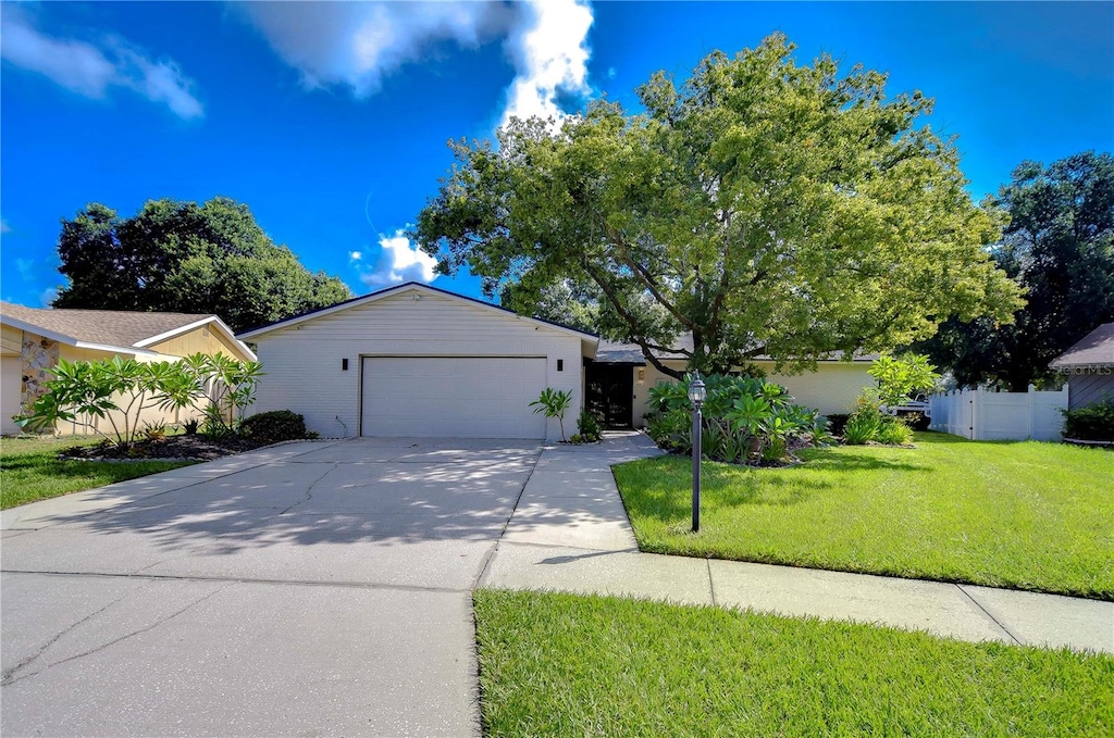 view of front of property featuring a garage and a front lawn