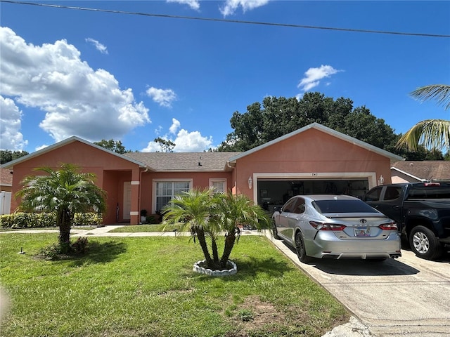 single story home featuring a garage and a front lawn