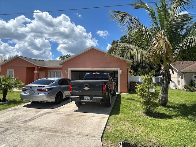 single story home featuring a garage and a front yard