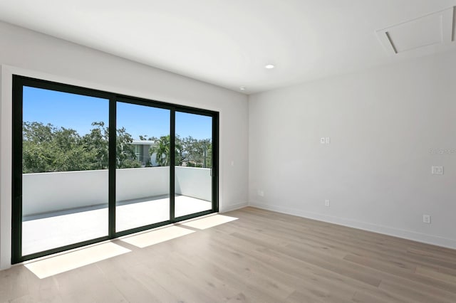 empty room with light hardwood / wood-style flooring