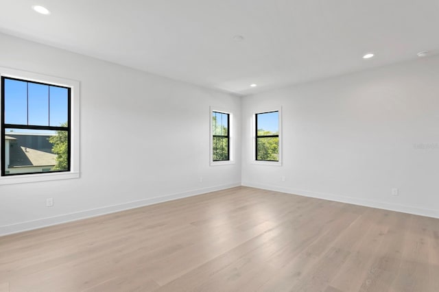 unfurnished room with light hardwood / wood-style floors