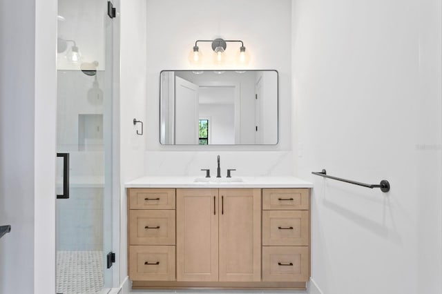 bathroom with vanity and a shower with shower door