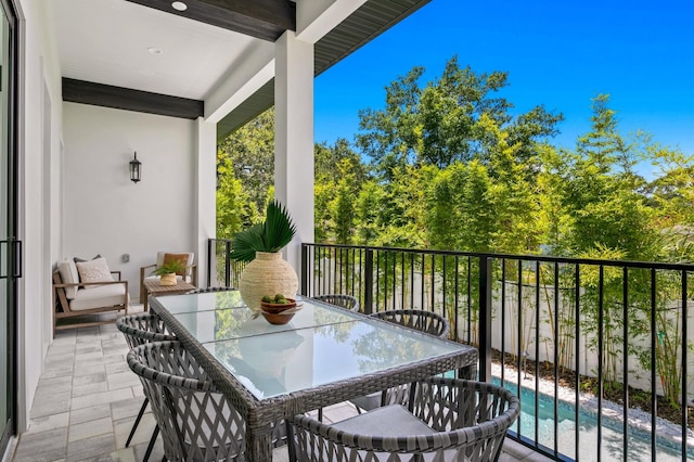 balcony featuring a fenced in pool