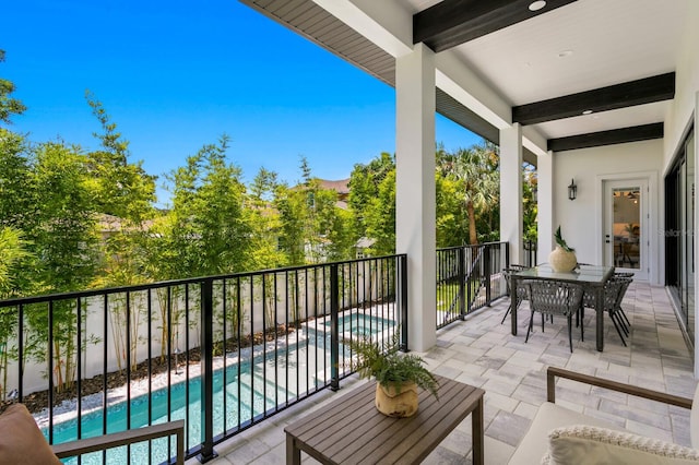 balcony with a fenced in pool