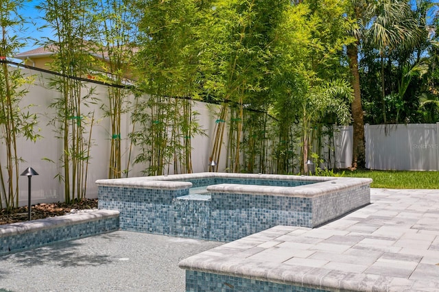 view of swimming pool with a patio and an in ground hot tub