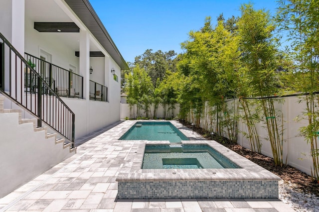 view of swimming pool with an in ground hot tub and a patio area