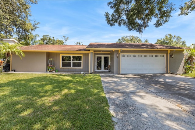 ranch-style home with a garage and a front yard