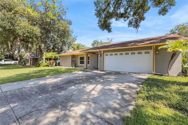 ranch-style house featuring a garage and a front yard