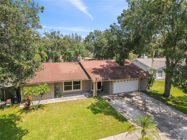 ranch-style house featuring a garage and a front lawn