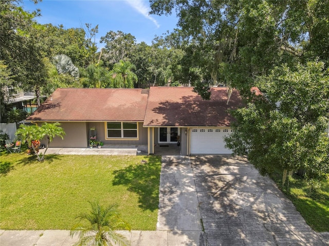 ranch-style home with a front yard and a garage