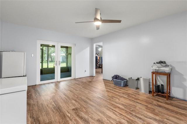 unfurnished living room with ceiling fan, hardwood / wood-style floors, and french doors