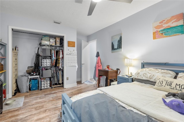 bedroom with ceiling fan, light hardwood / wood-style flooring, and a closet