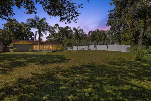 view of yard at dusk