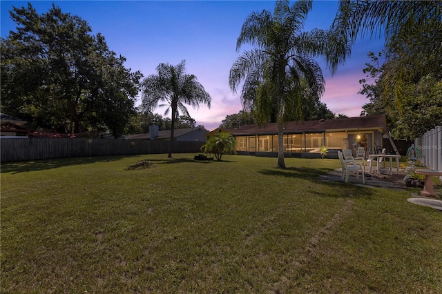 view of yard at dusk