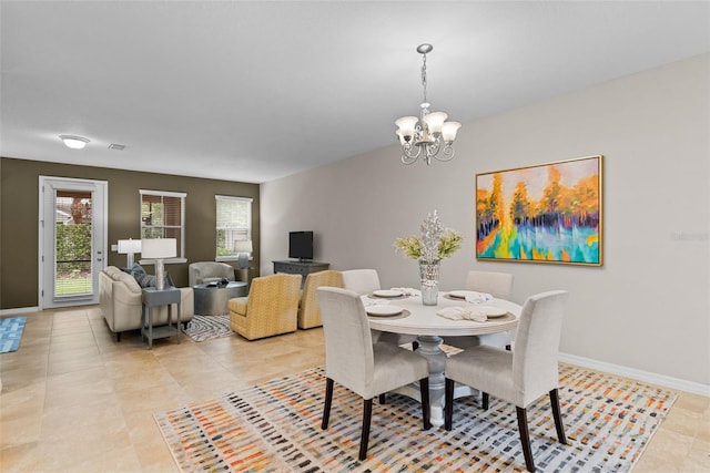 tiled dining space featuring a notable chandelier