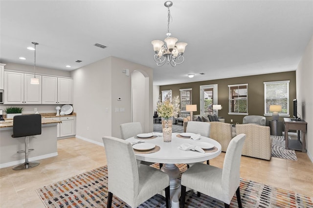 tiled dining area with a notable chandelier