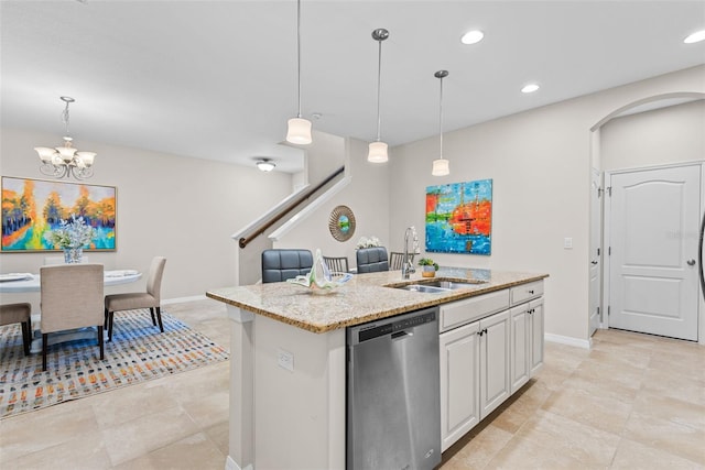 kitchen with a center island with sink, sink, white cabinetry, hanging light fixtures, and dishwasher