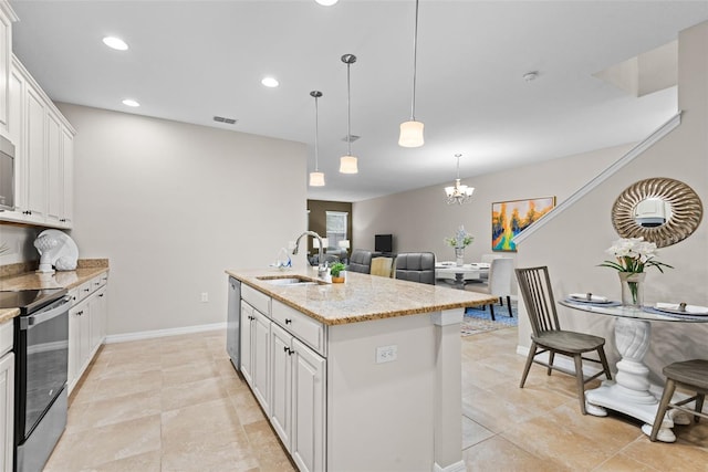 kitchen featuring white cabinetry, appliances with stainless steel finishes, sink, and an island with sink