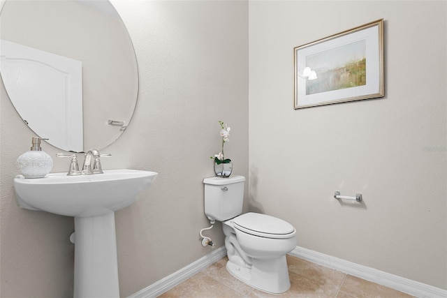 bathroom with toilet and tile patterned flooring