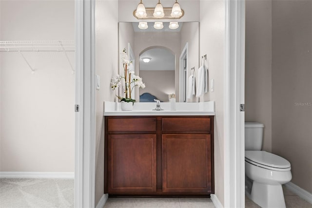 bathroom with tile patterned floors, vanity, and toilet