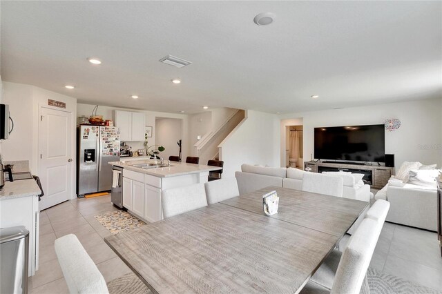 tiled dining space featuring sink