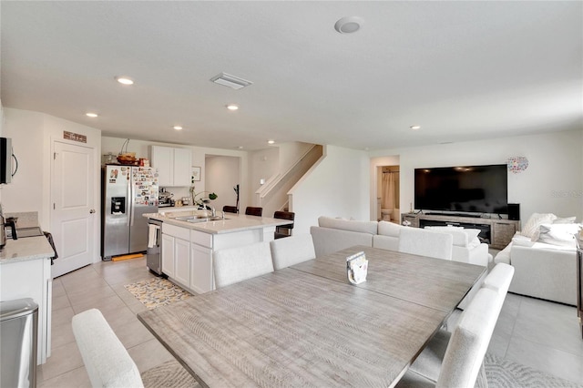 dining area featuring sink and light tile patterned floors