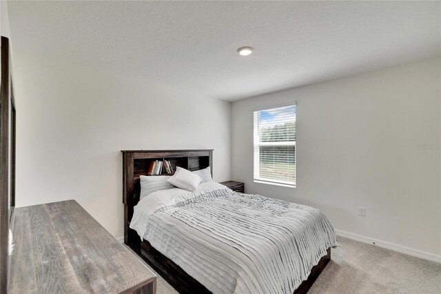 carpeted bedroom with a textured ceiling