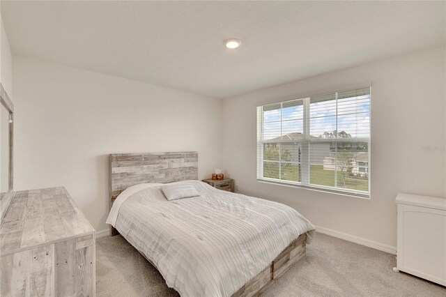 bedroom with light colored carpet