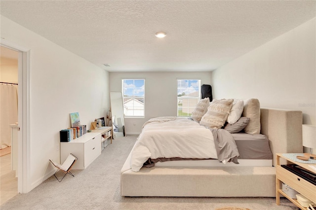 carpeted bedroom with a textured ceiling