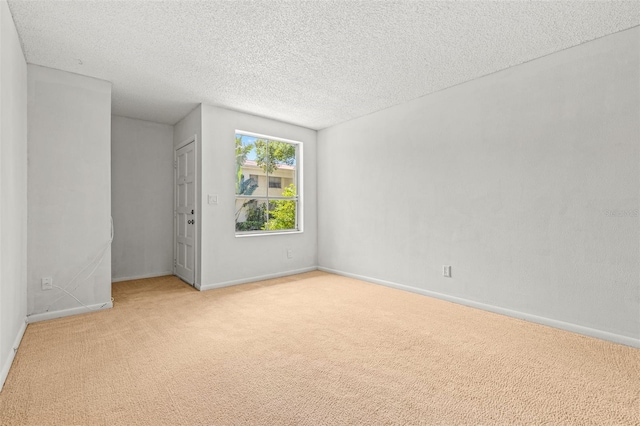 unfurnished bedroom featuring light colored carpet and a textured ceiling