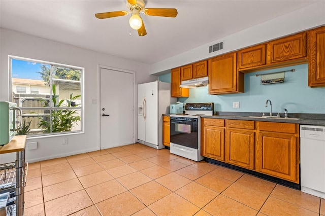 kitchen featuring ceiling fan, sink, light tile patterned floors, and white appliances