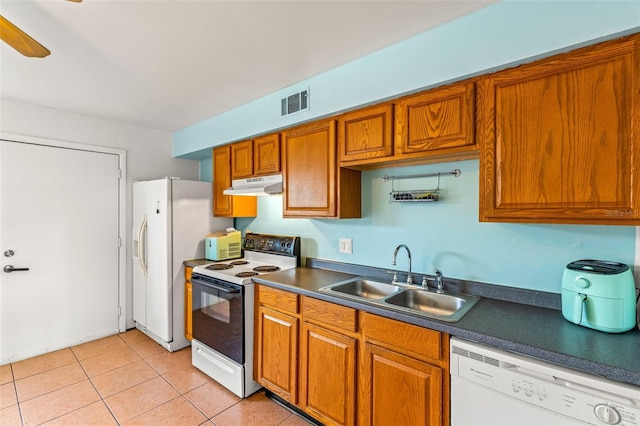 kitchen featuring light tile patterned floors, white appliances, sink, and ceiling fan