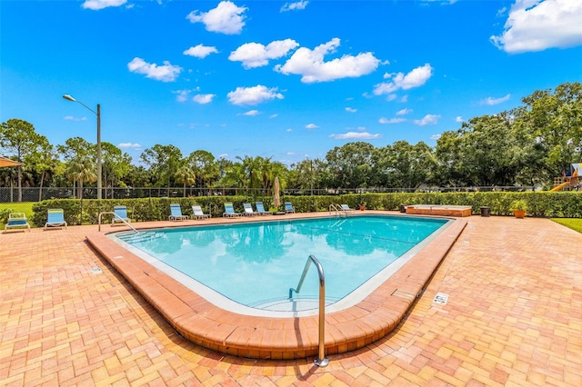 view of swimming pool with a patio area