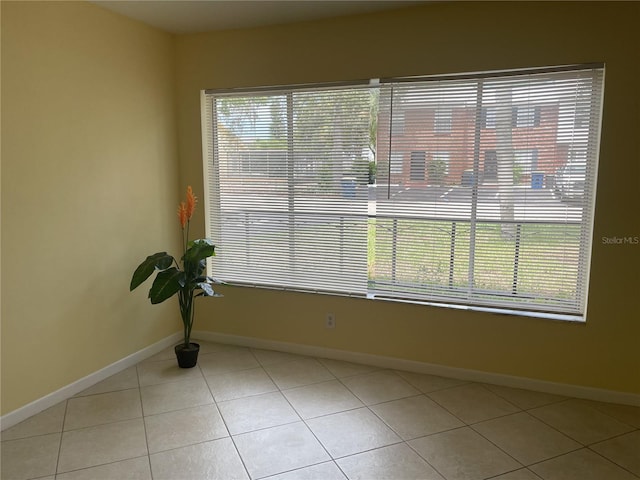 spare room featuring light tile patterned flooring